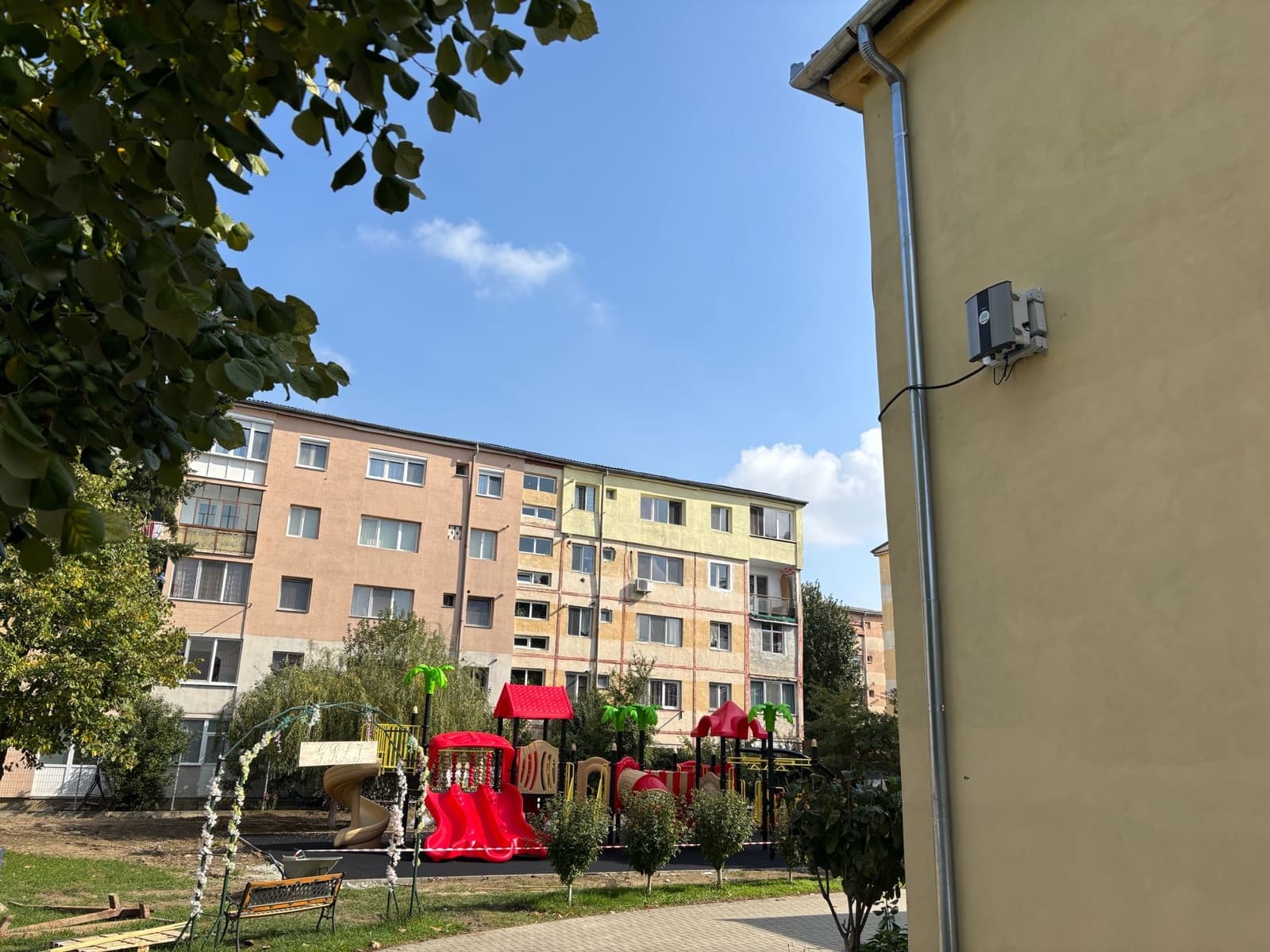 Polludrone station on a residential building overlooking apartment blocks and a children's playground